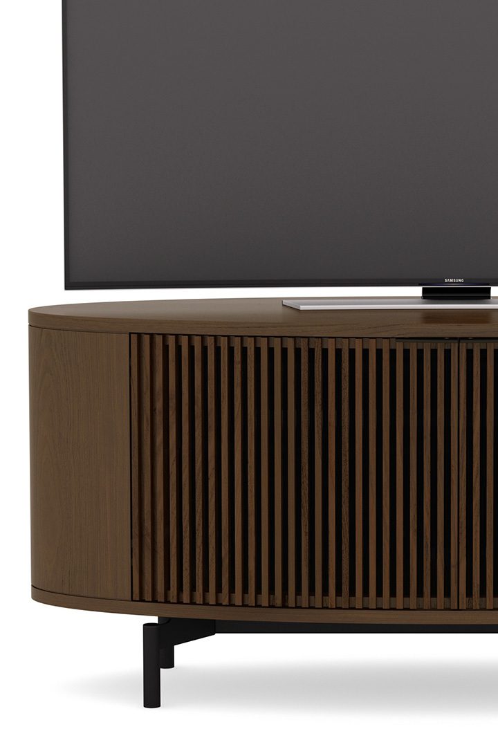 The Olis TV Stand from BDI features louvered doors that conceal a speaker and AV system