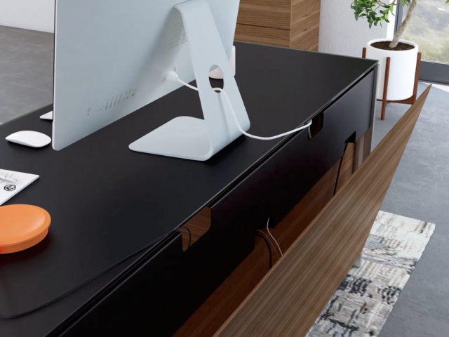 Magnetic rear access cable management panel on the Sequel 6021 executive desk by BDI furniture.